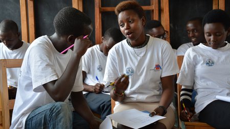 Young people in a classroom in a group discussion.