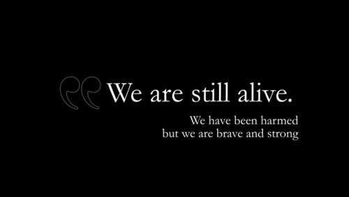 Black area with the words "We ar still alive". We have been harmed but we are brave and strong. 