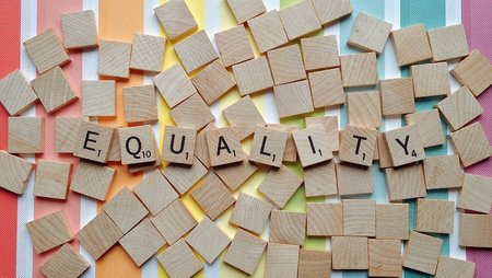 Letters from a game of Scrabble spell out the word “equality”.
