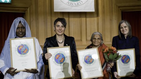 The four women who were awarded the 2008 Right Livelihood Award posing for a group photo, holding their framed award certificates.