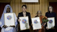 The four women who were awarded the 2008 Right Livelihood Award posing for a group photo, holding their framed award certificates.