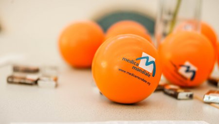 A selection of anti-stress balls bearing the logo of medica mondiale.